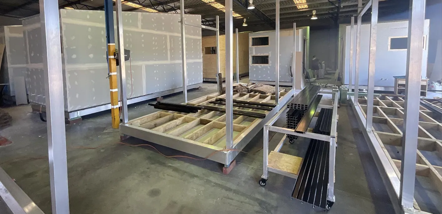 Workshop floor with fabricated metal floor frames and wall framing for modular structures